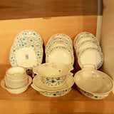 Set of ceramic dishes with floral patterns on a wooden surface