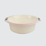 Beige bowl with pink rim and floral patterns on a light gray background