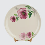 Decorative plate with pink floral design on a white background