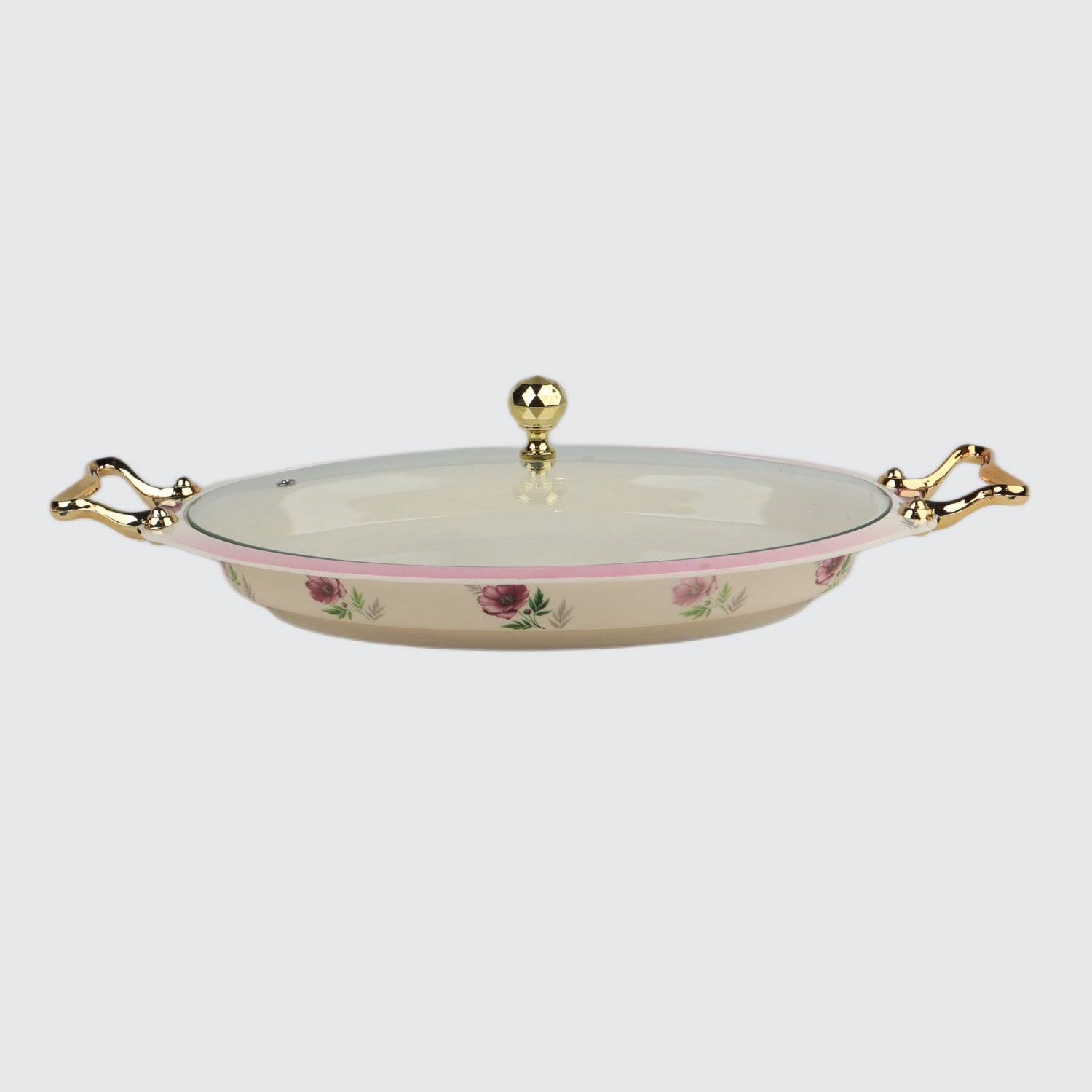 Decorative ceramic dish with floral patterns and gold handles on a light gray background