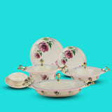 Set of ceramic dishes with floral designs on a turquoise background
