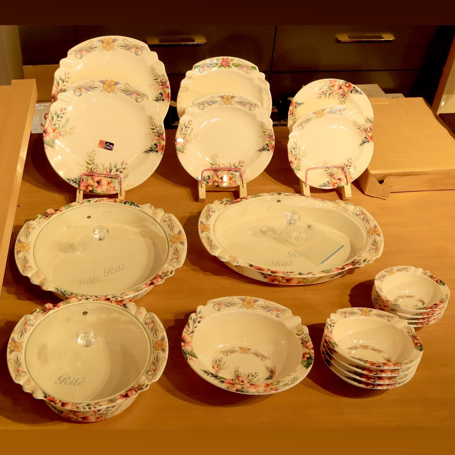 Set of floral-patterned ceramic dishes on a wooden surface