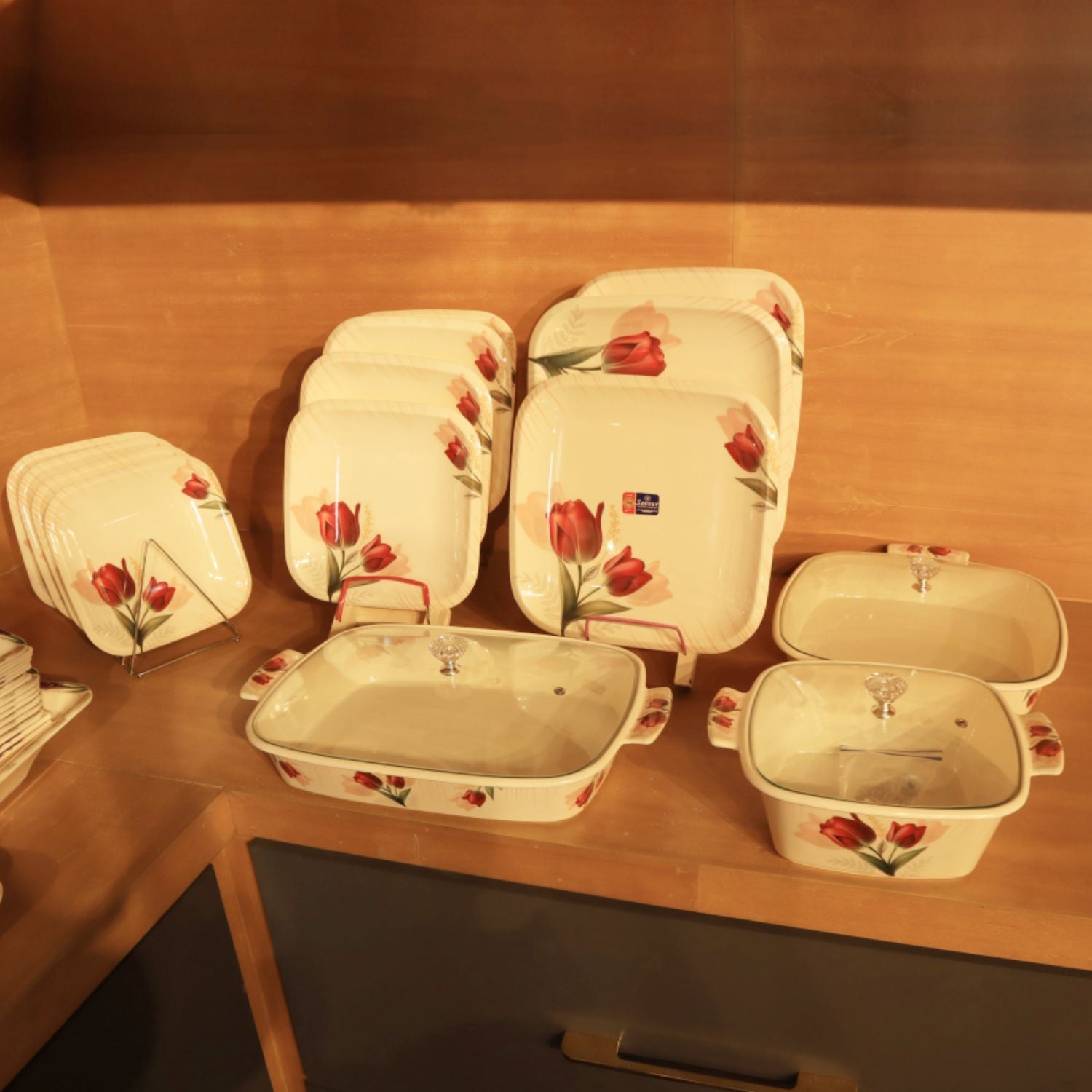 Set of ceramic dishes with floral design on a wooden surface