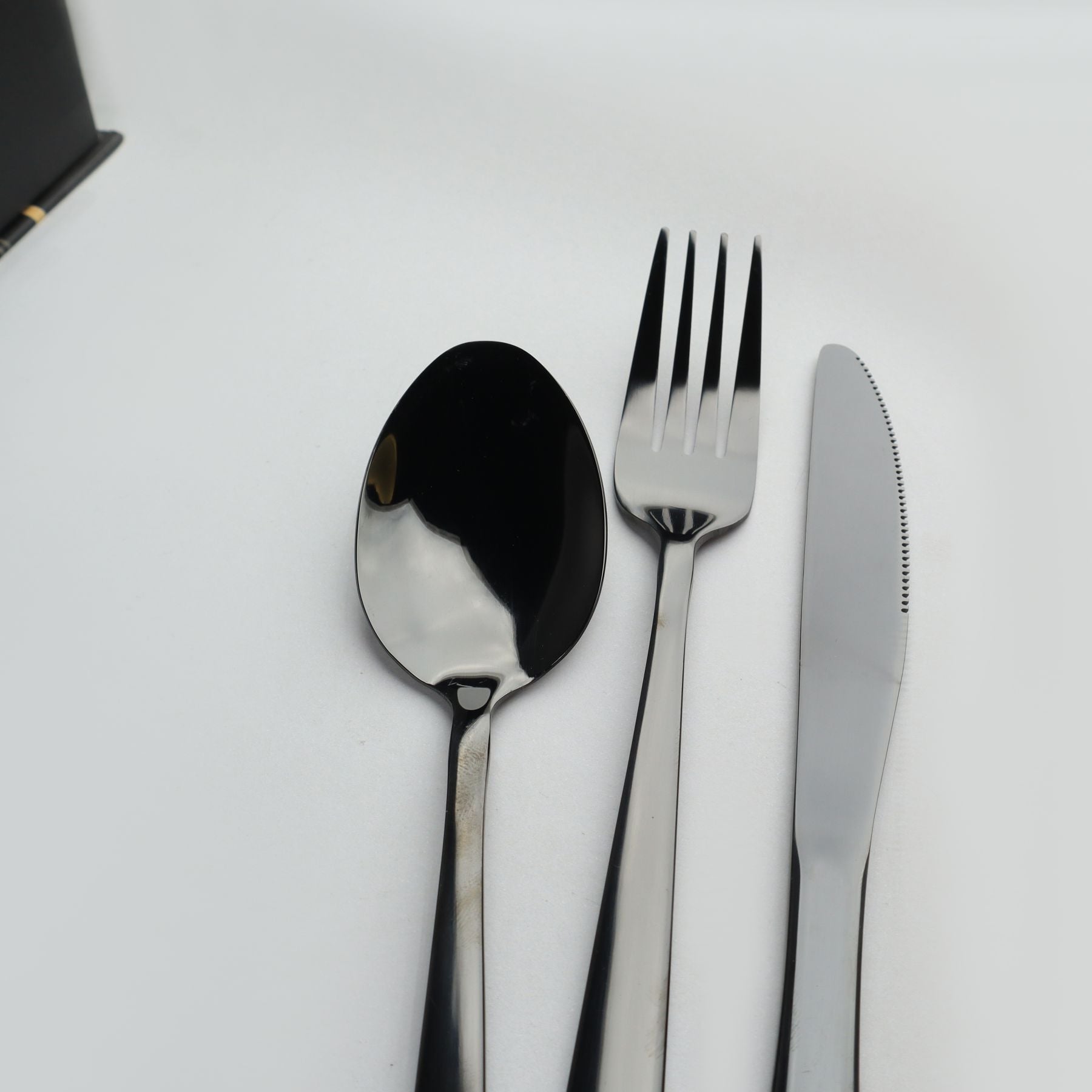 Stainless steel spoon, fork, and knife on a white background by majestic chef cookware at reasonable price