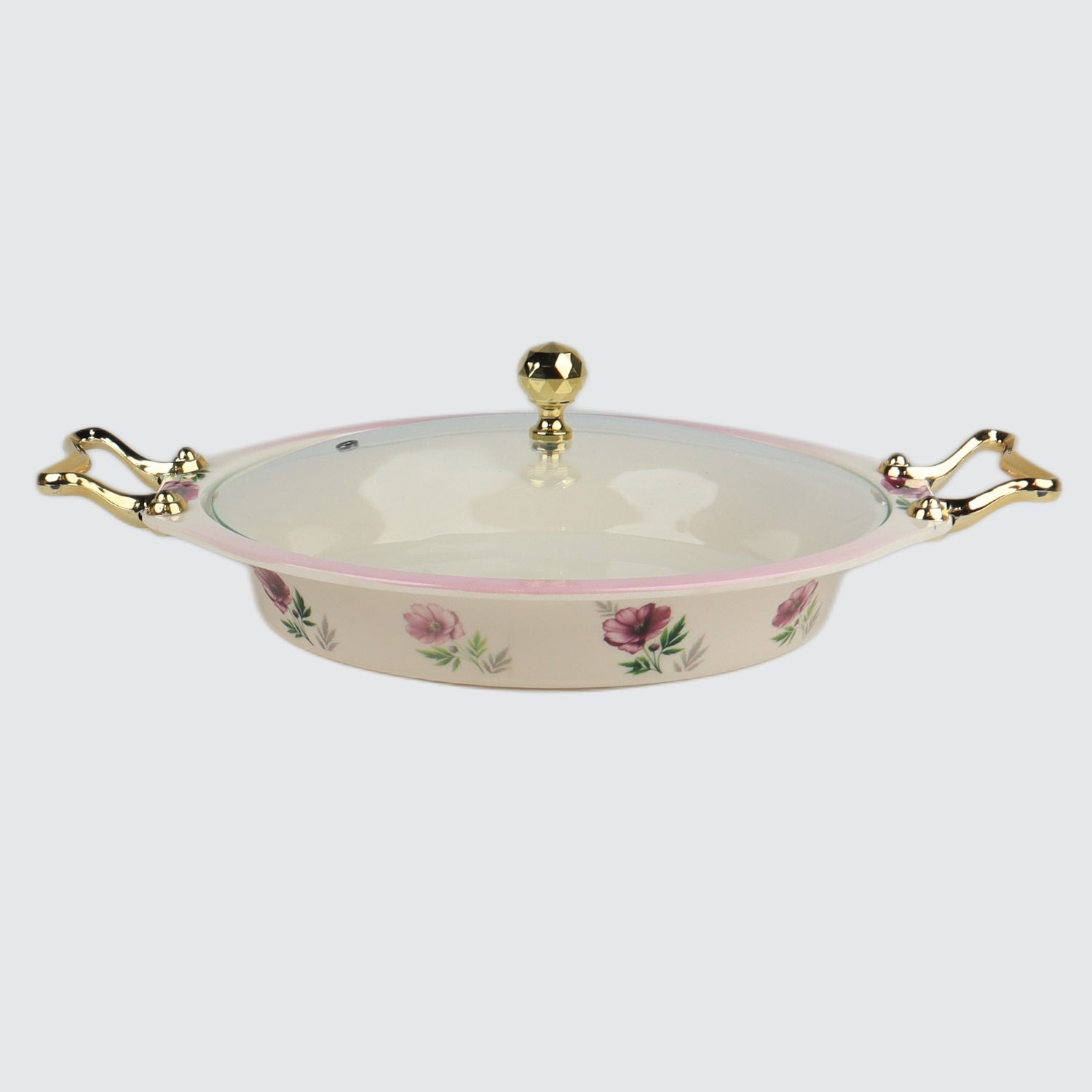 Decorative ceramic dish with floral patterns and gold handles on a white background