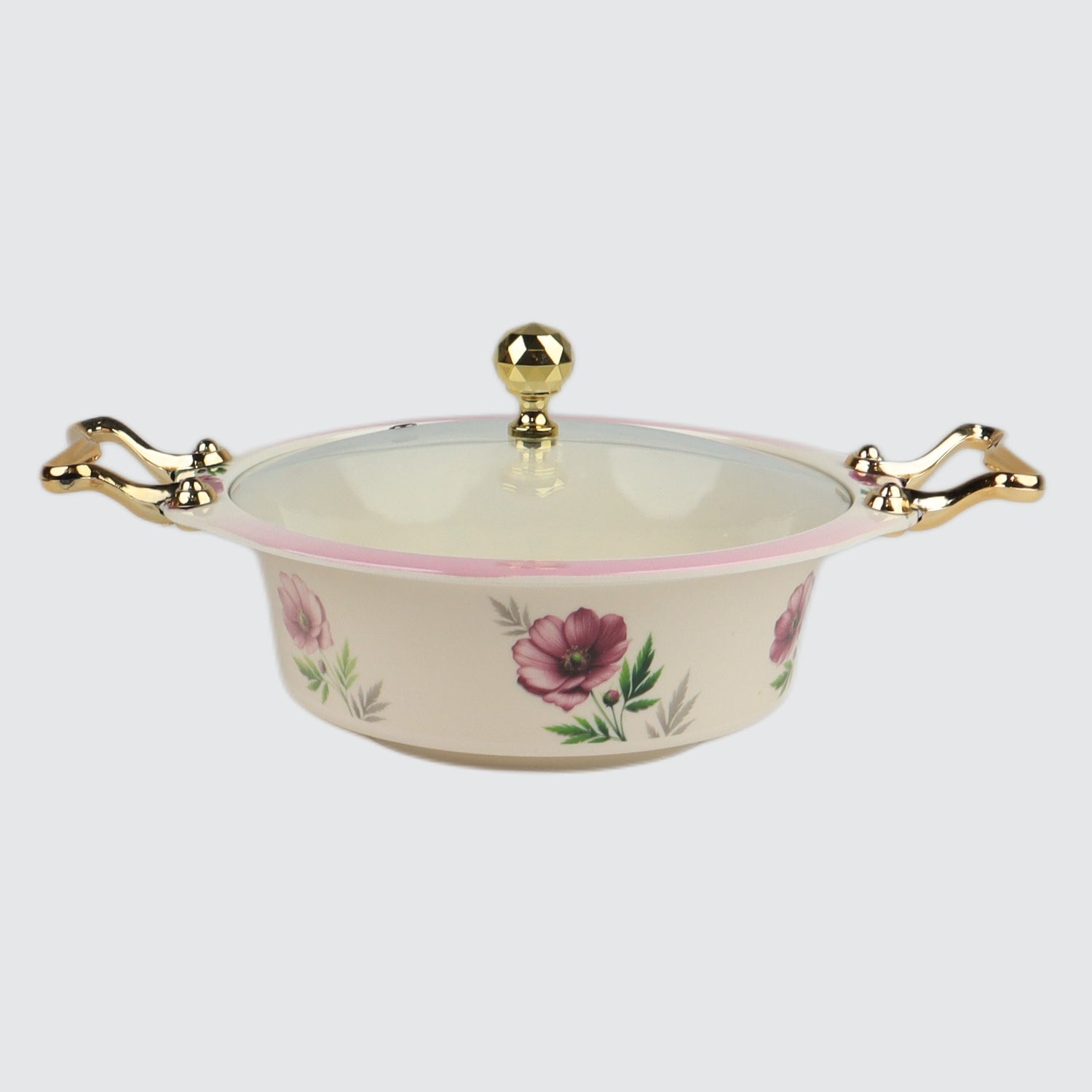 Decorative ceramic dish with floral design and gold handles on a white background