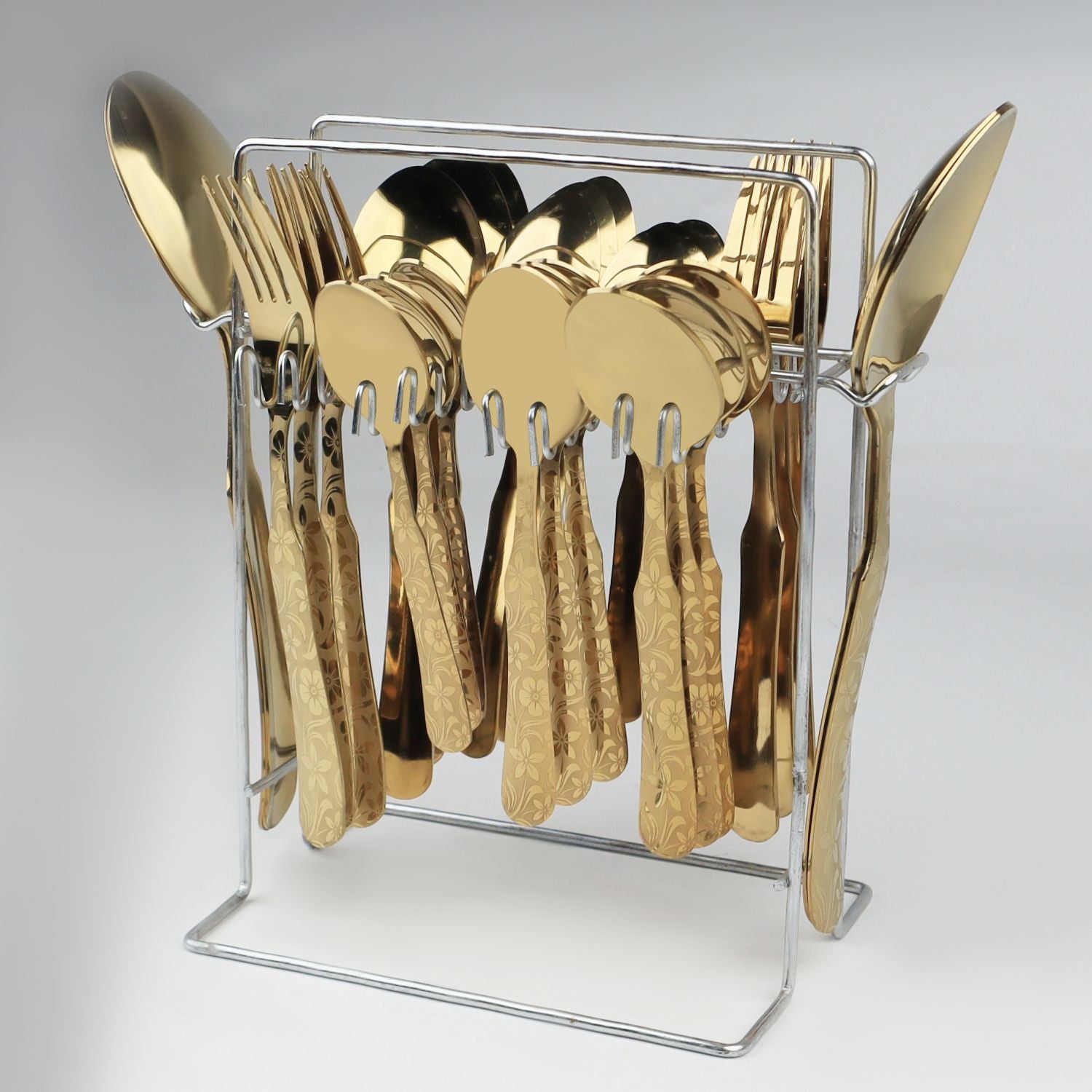 Gold cutlery set in a clear stand on a light gray background at affordable price from best cookware brand in Pakistna