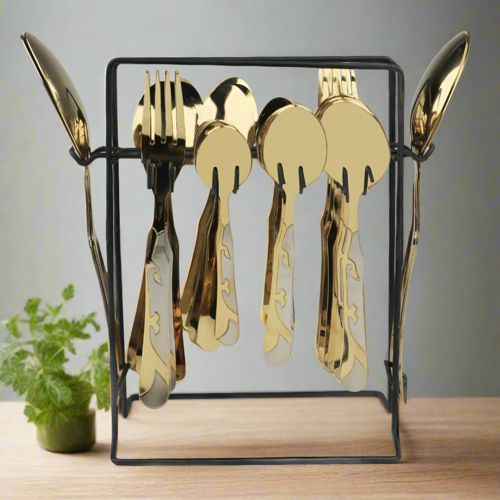 Gold cutlery set in a clear stand on a light gray background at affordable price from best cookware brand in Pakistna