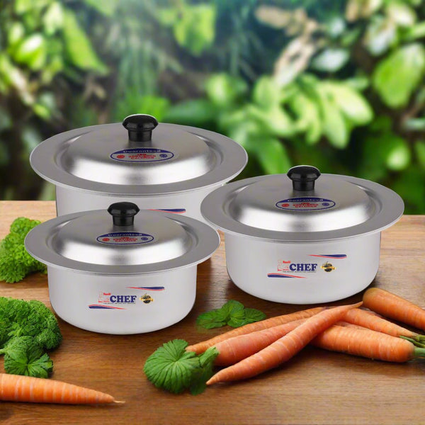 Three Silvano mini aluminium pots with matching lids on a wooden worktop