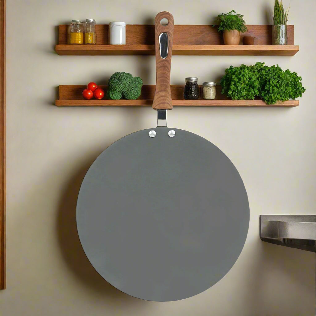 Round gray pan with a wooden handle on a light gray background