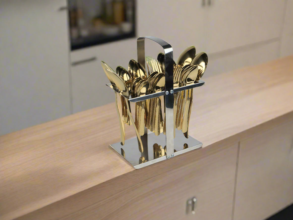 Gold cutlery set in a stand on a kitchen counter