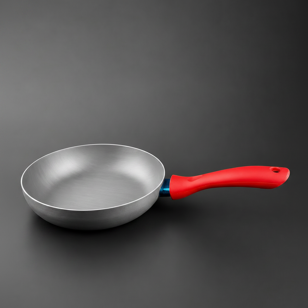 Majestic Chef  silver aluminum frying pan with a bright red handle, shown on a dark gray background.

