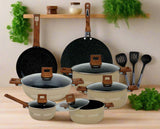 Set of cookware with speckled black interior and wooden handles on a white background